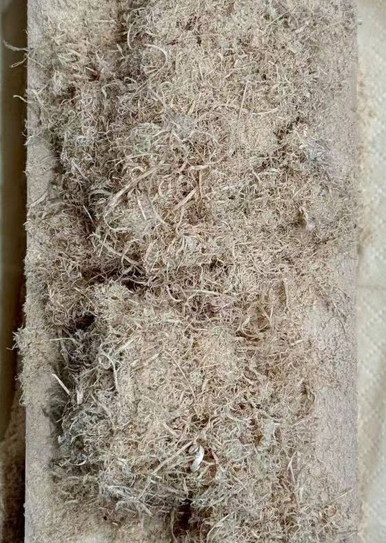 Fine wood fibres piled on a block